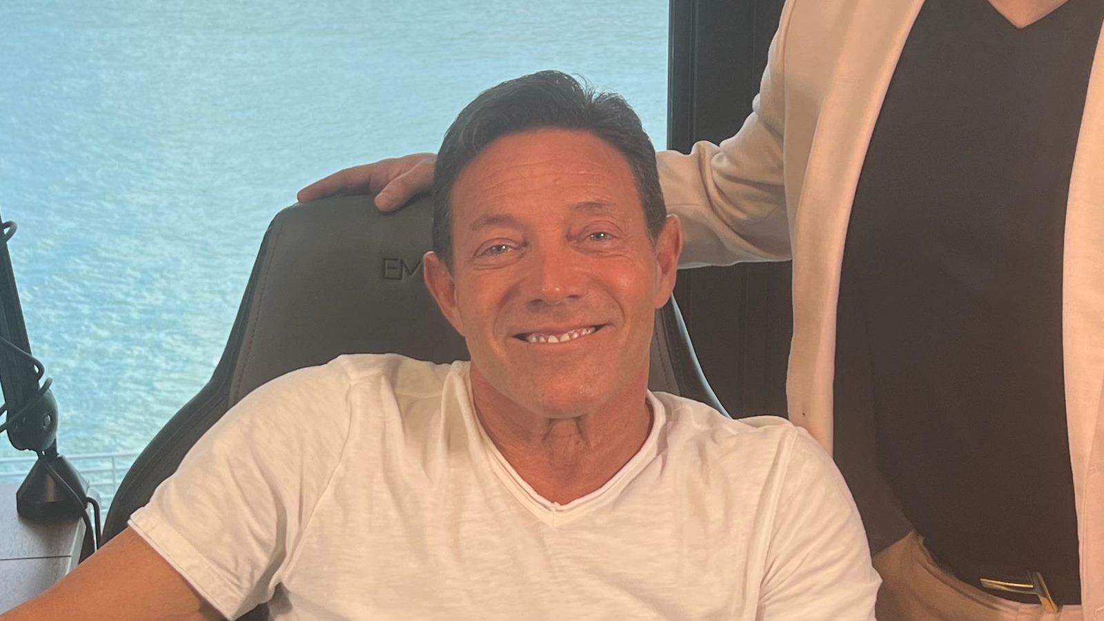 Jordan Belfort today, seated at a microphone in a podcast studio