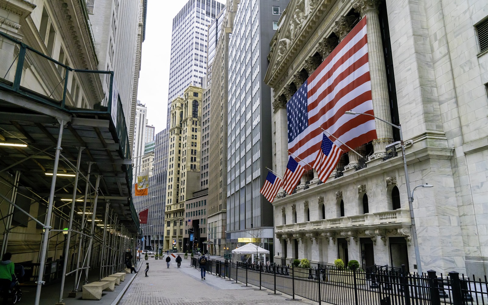 A deserted Wall Street in front of the flag-draped New York Stock Exchange in March 2020