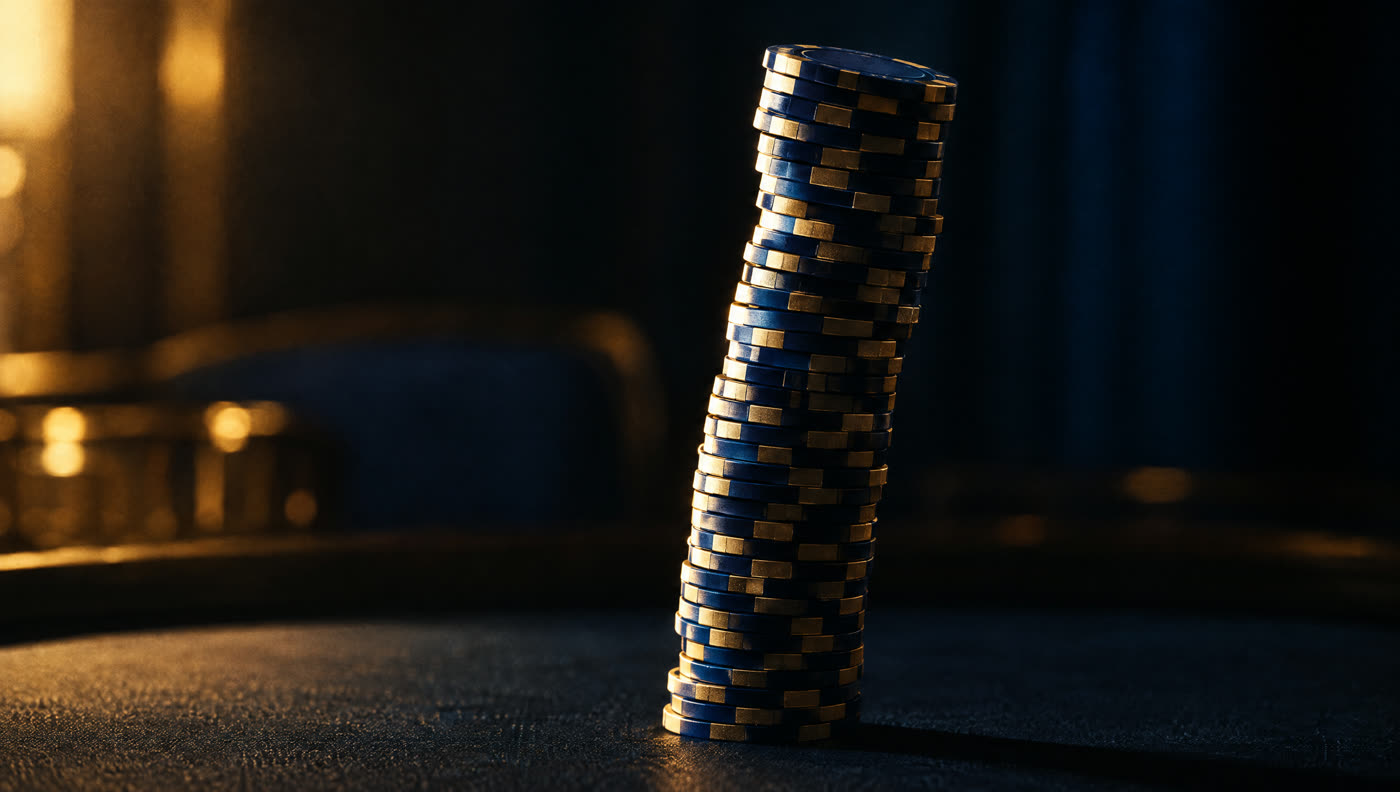 A towering stack of casino chips leaning precariously on a dark table